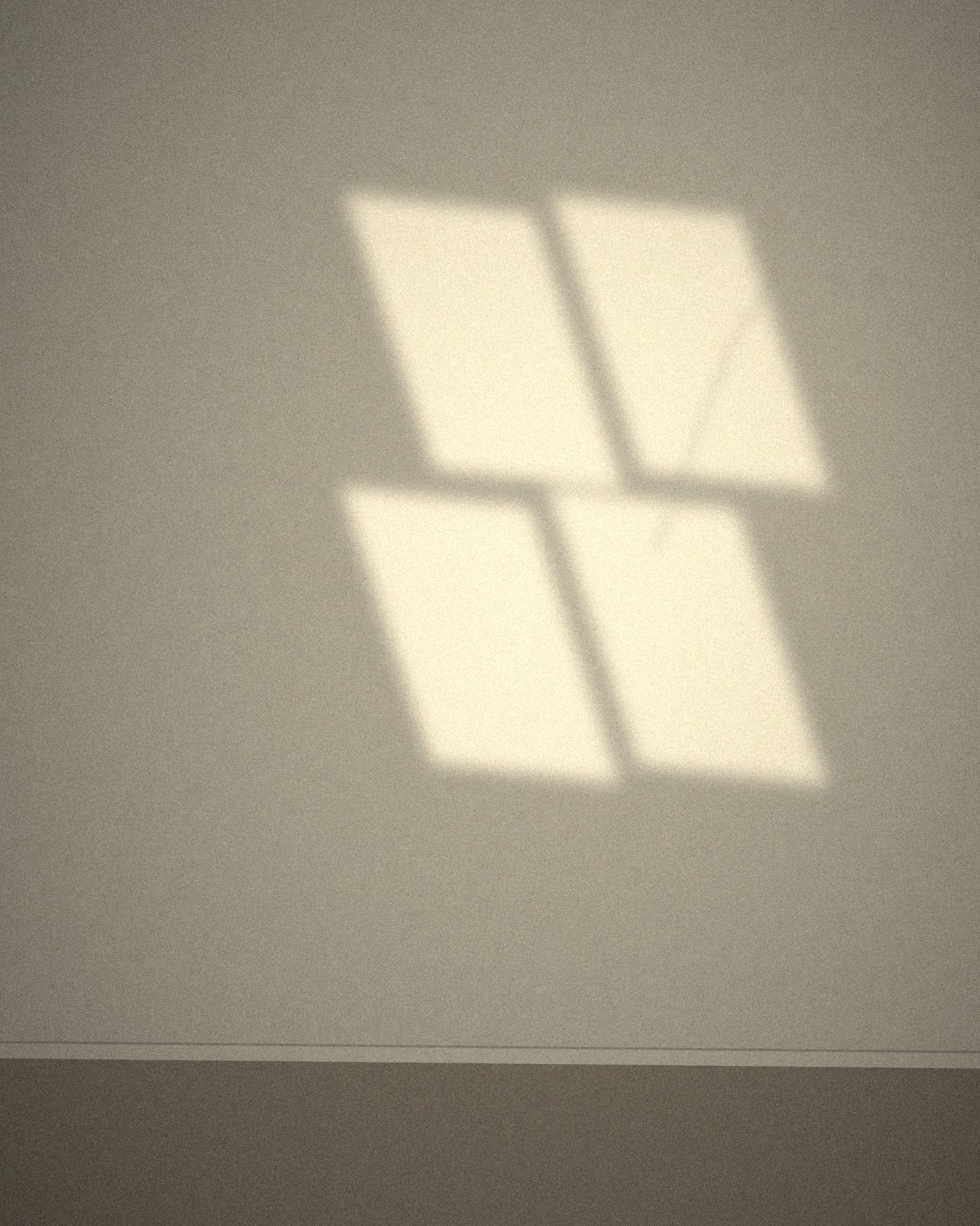 Afternoon sunlight falling through a window onto an empty wall.